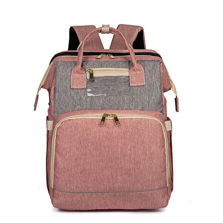 Versatile diaper backpack for travel, converts to a safe, comfortable foldable baby bassinet. Multi-pocket design.