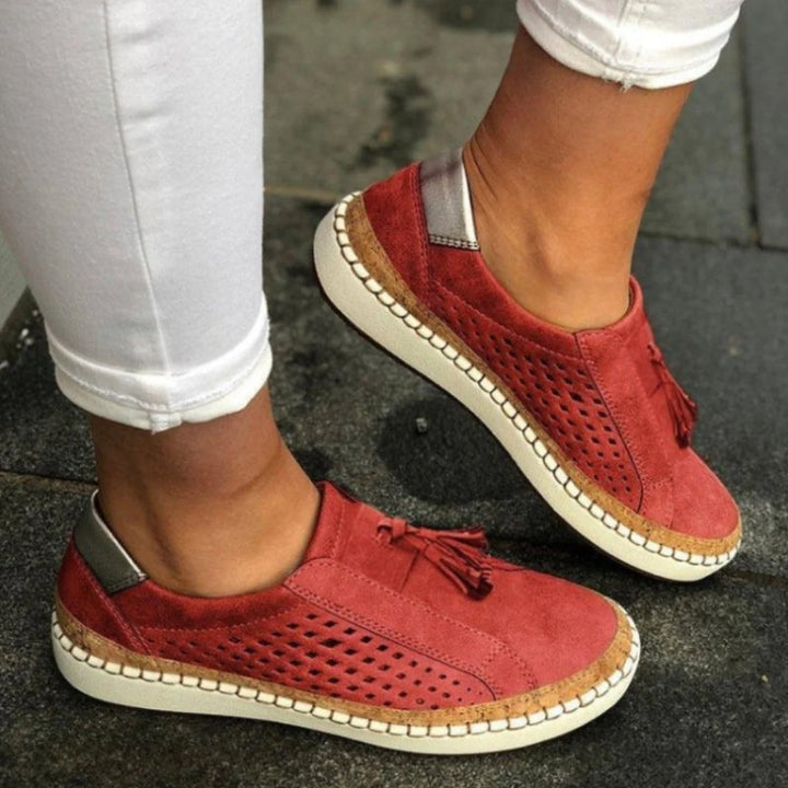 Close-up of unisex black slip-on shoes showcasing orthopedic arch support and breathable design for casual wear