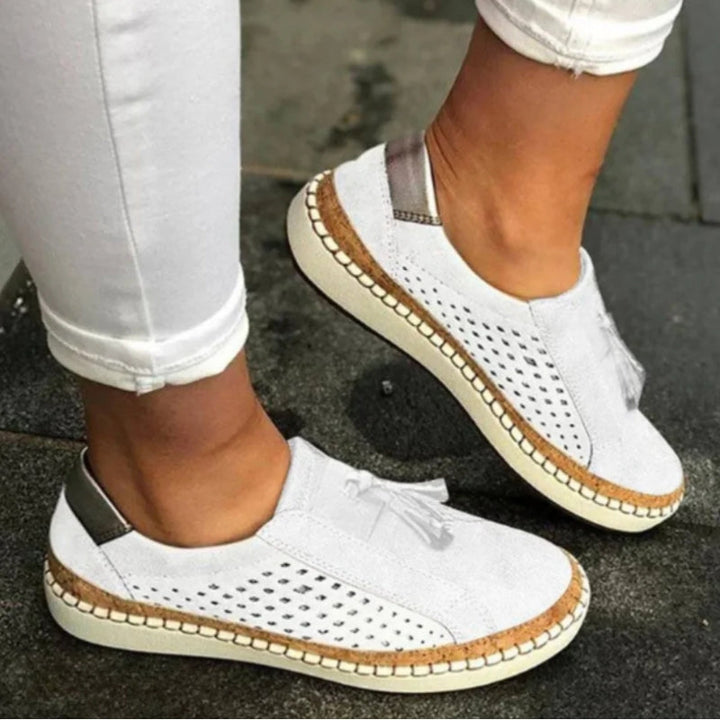 Pair of unisex slip-on athletic shoes with enhanced arch support, perfect for walking and everyday comfort