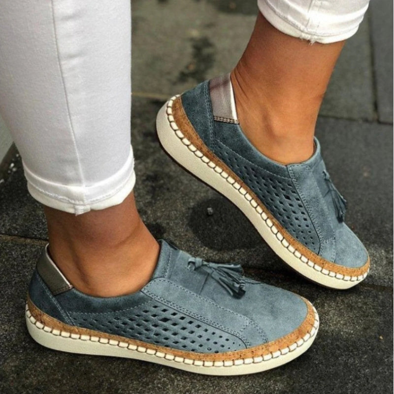 Side view of unisex blue slip-on comfort footwear, highlighting orthopedic features and breathable construction