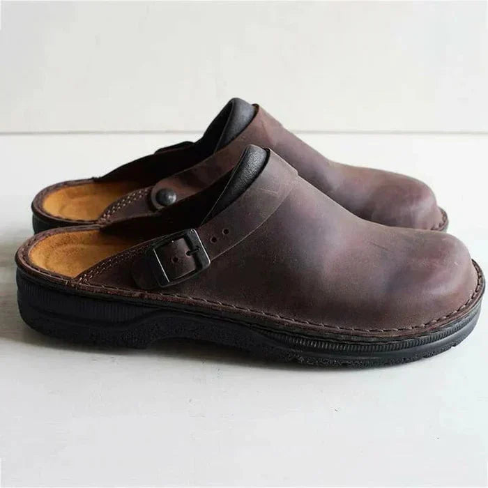 Unisex orthopaedic slip-on clogs in distressed leather, showing arch support and comfort features