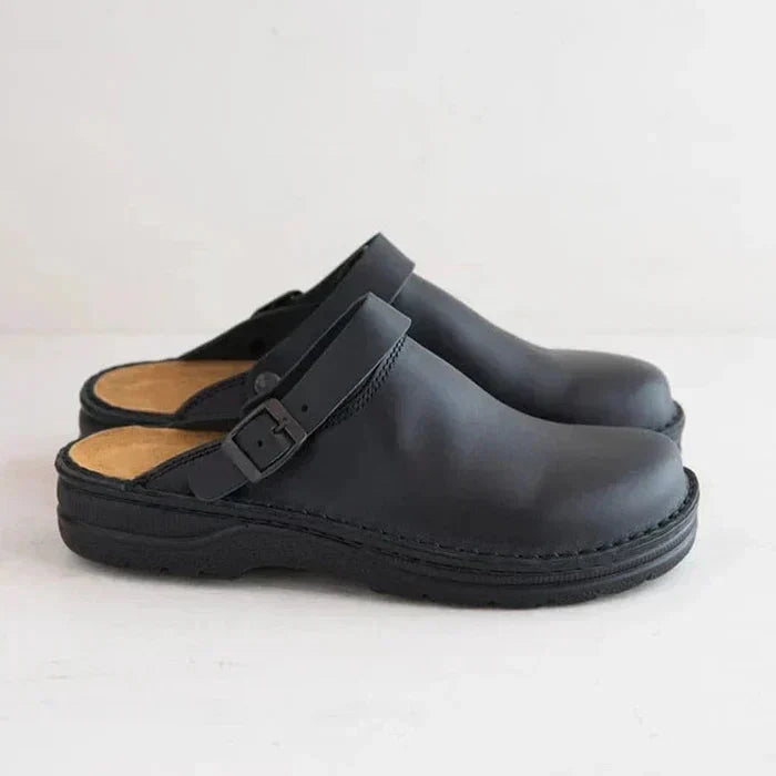 Bottom sole detail of a brown orthopaedic leather clog, showing slip-resistant traction