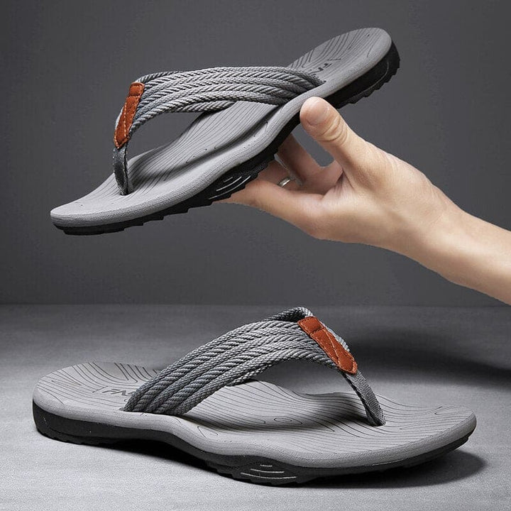 Unisex arch support slippers in a neutral color, promoting foot health and comfort.