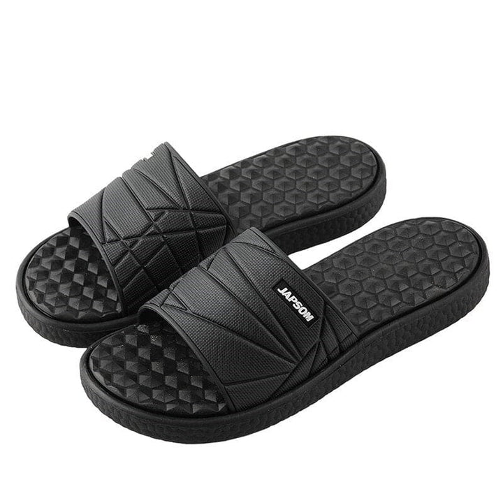 Close-up of a unisex slipper showcasing its orthopedic arch support design.