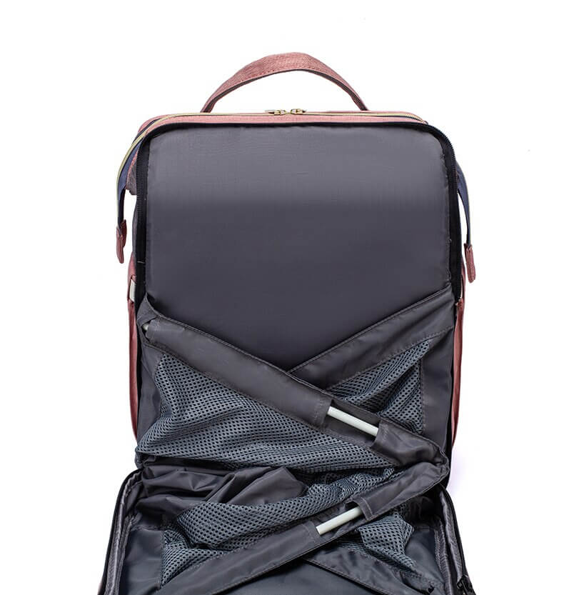 On-the-go parent essential: portable baby bed, changing station & diaper bag.