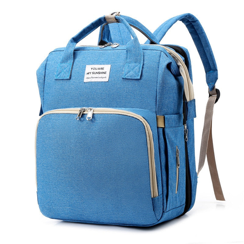 Multifunction travel backpack with convertible baby bed & changing station.