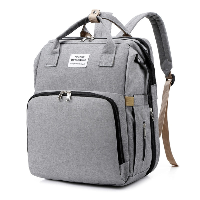 Waterproof diaper bag & portable bassinet, essential baby gear for parents.