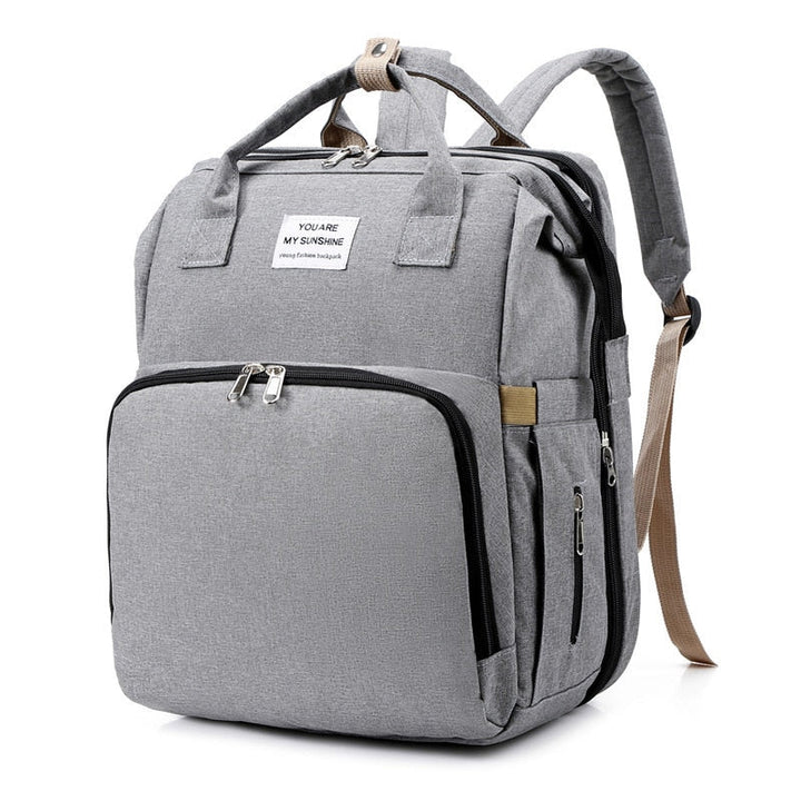 Waterproof diaper bag & portable bassinet, essential baby gear for parents.