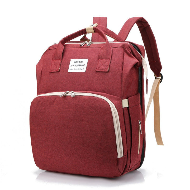 Portable baby changing station & diaper bag in a unisex travel backpack.