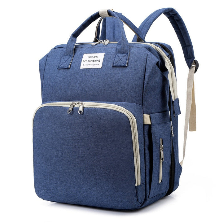 Compact multifunction baby bed & nappy bag for on-the-go parents.