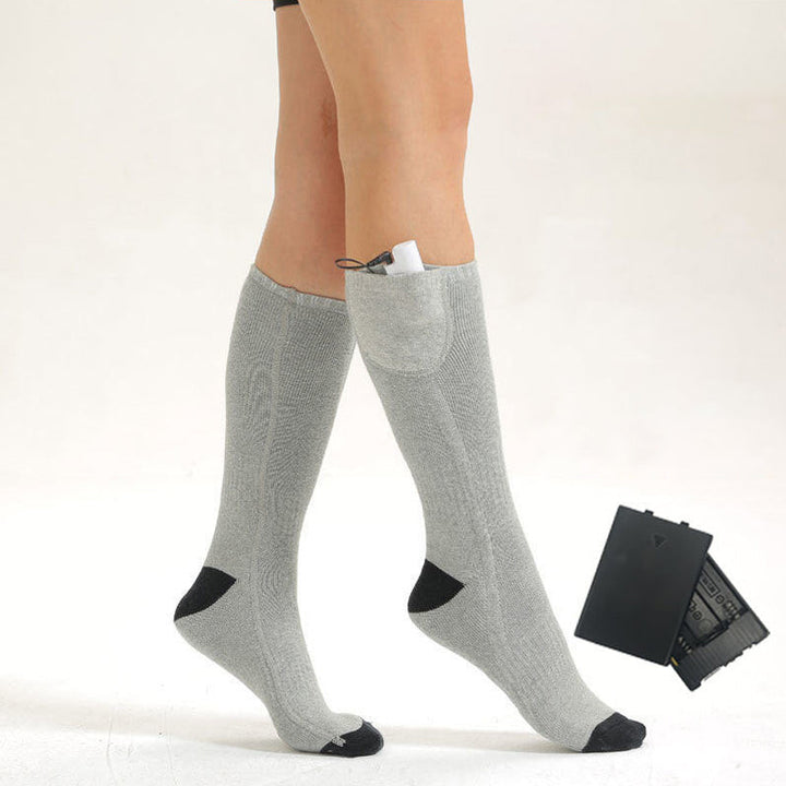 A pair of HeatWave rechargeable heated socks displayed with a charging cable.