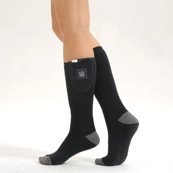 Heated socks for hiking in snow, rechargeable, anti-cold, and essential winter outdoor gear.