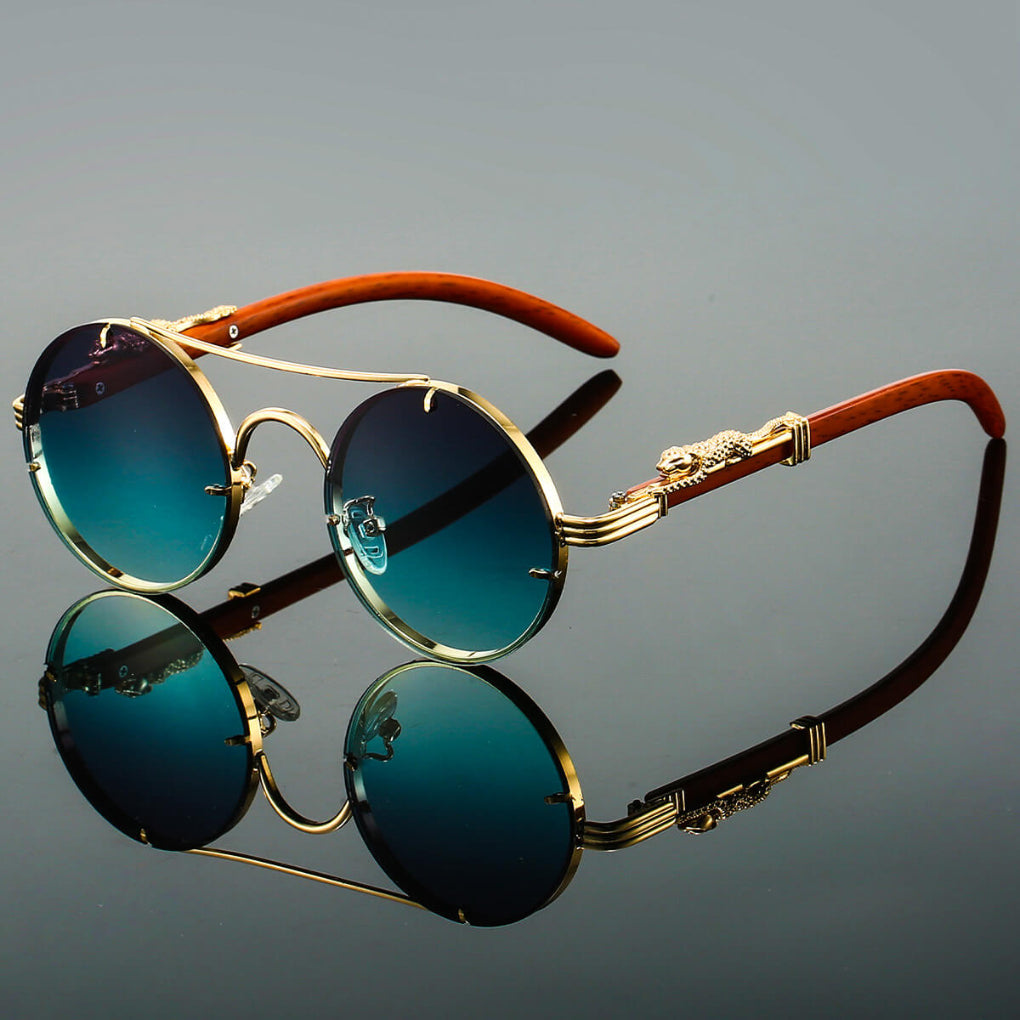 Close-up of vintage oval metal sunglasses, highlighting the sleek frame and dark lenses.