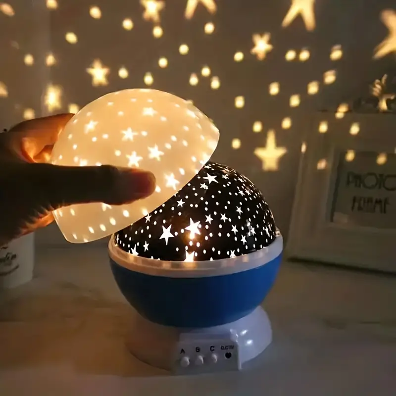 Rotating star projector night light, casting beautiful celestial patterns on a child's bedroom ceiling.
