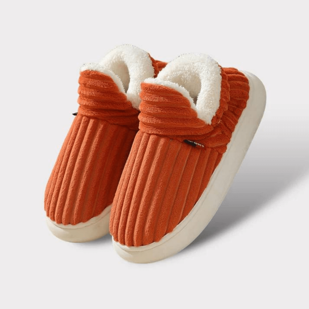 Close-up of a pair of plush thermal unisex slippers, demonstrating soft texture & warm lining.