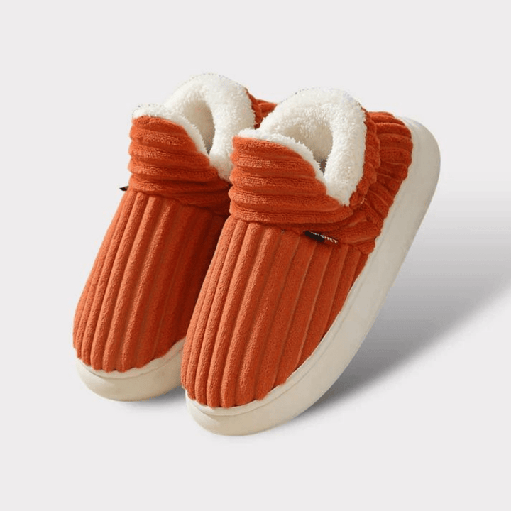 Close-up of a pair of plush thermal unisex slippers, demonstrating soft texture & warm lining.