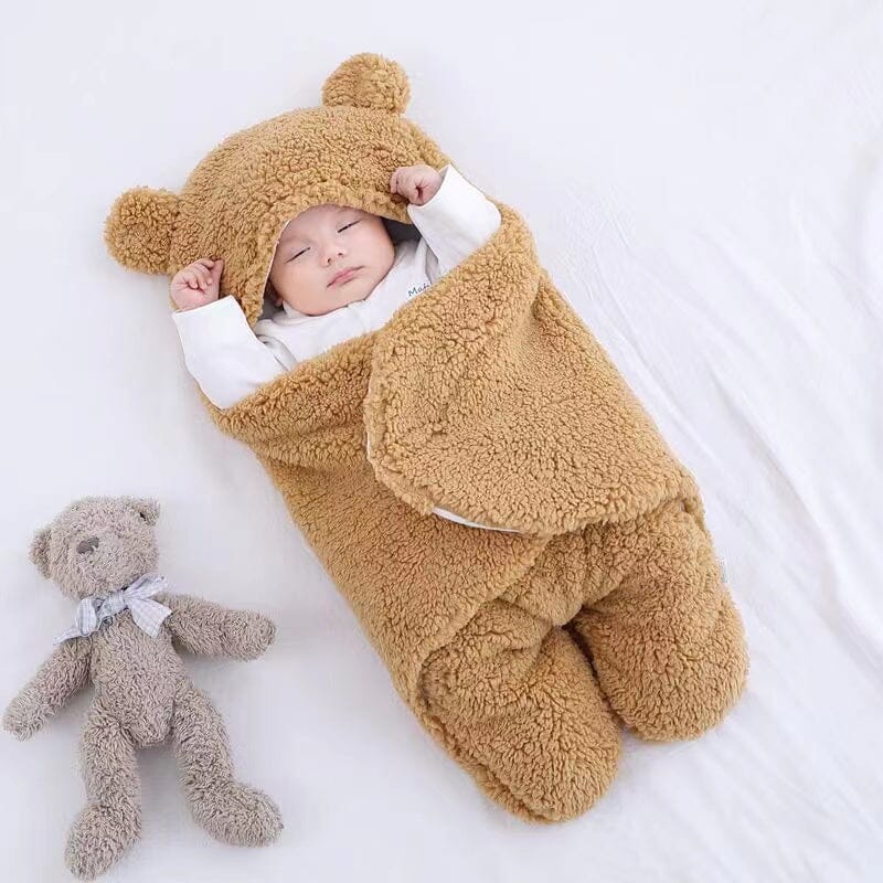 Warm winter baby swaddle with plush quilted fabric & bear ears. Perfect cozy sleepsack for newborns & infants.