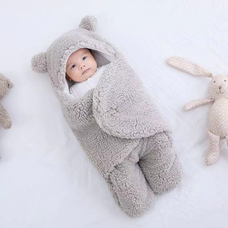 Newborn ultra-soft quilted baby swaddle with adorable bear ears. Plush and cozy infant sleepsack for warmth.