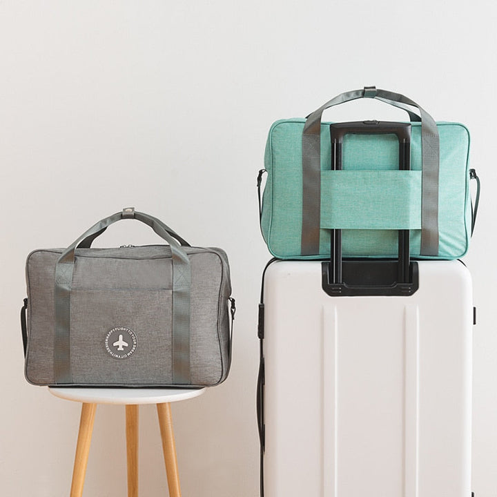 Compact carry-on flight bag that slides over suitcase handles, ideal for organizing travel essentials.