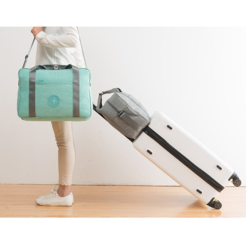 Efficient unisex travel accessory, a lightweight carry-on bag that attaches to luggage for convenience.