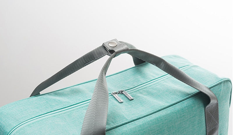 Foldable travel bag, attaches securely to suitcase handles for easy, hands-free carry-on journeys.