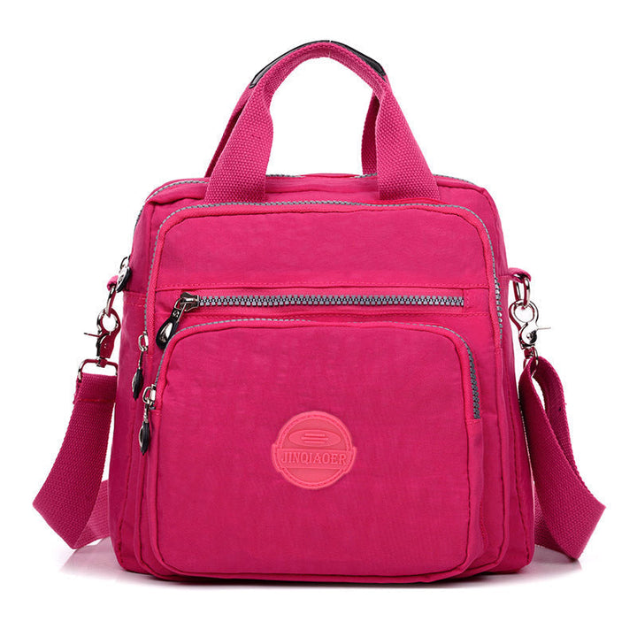 Detail of the zipper and pull on the water-resistant crossbody bag, emphasizing its quality and ease of use.