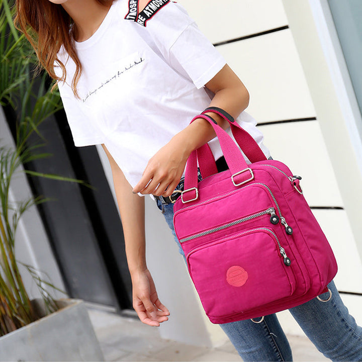 Close-up of the durable, water-resistant crossbody bag fabric, highlighting texture and quality stitching.