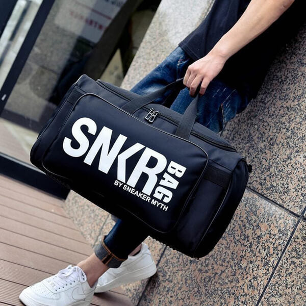 Unisex water-resistant sneaker & gear travel bag with adjustable dividers.
