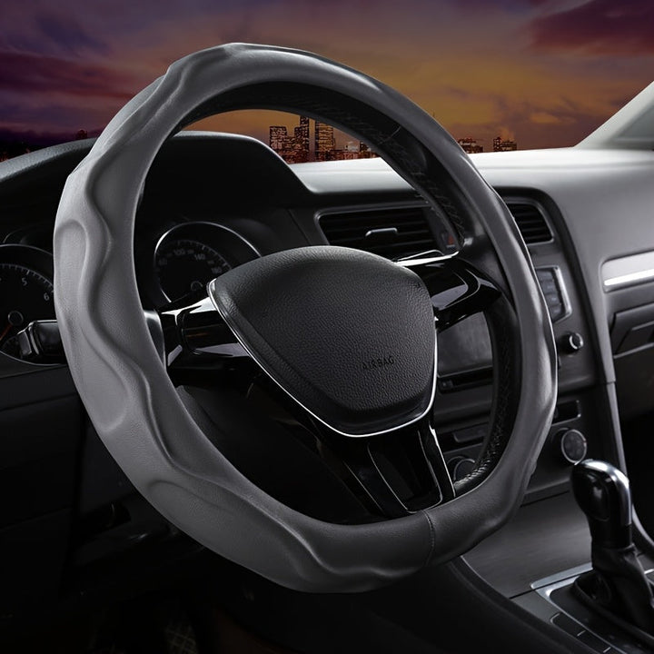 Universal PU leather steering wheel cover with non-slip grip for comfort & vehicle protection.