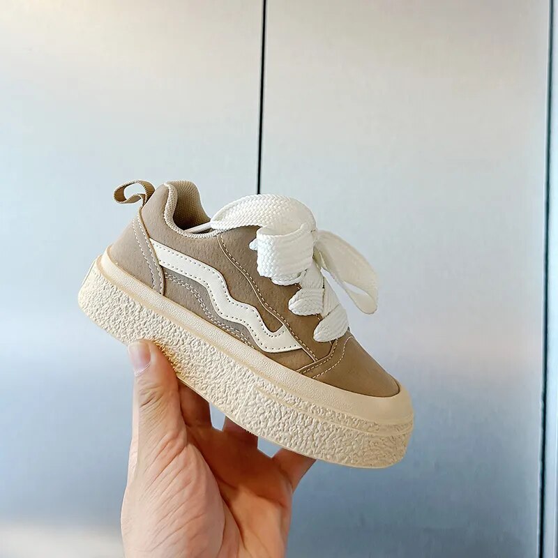 Comfortable infant footwear: playful sneakers with flexible soles and secure fit for toddlers' first steps.