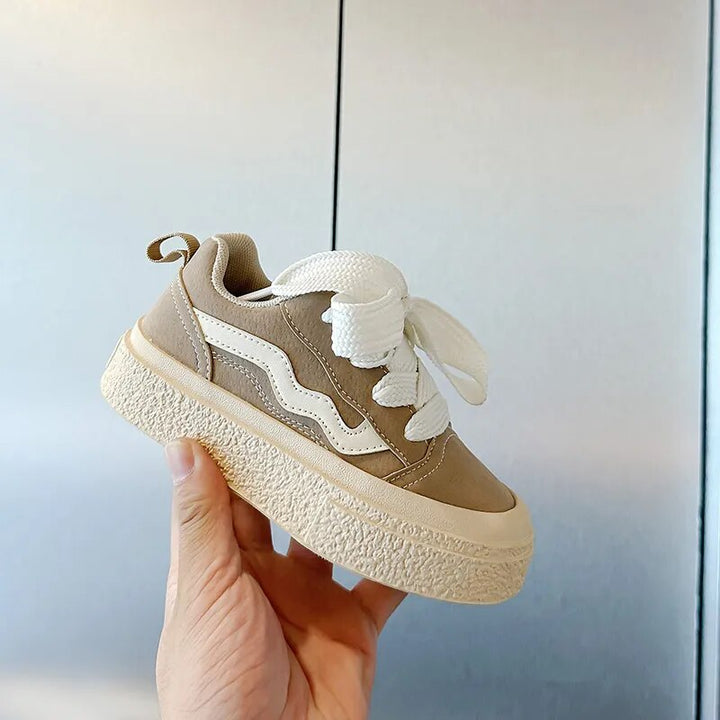 Comfortable infant footwear: playful sneakers with flexible soles and secure fit for toddlers' first steps.