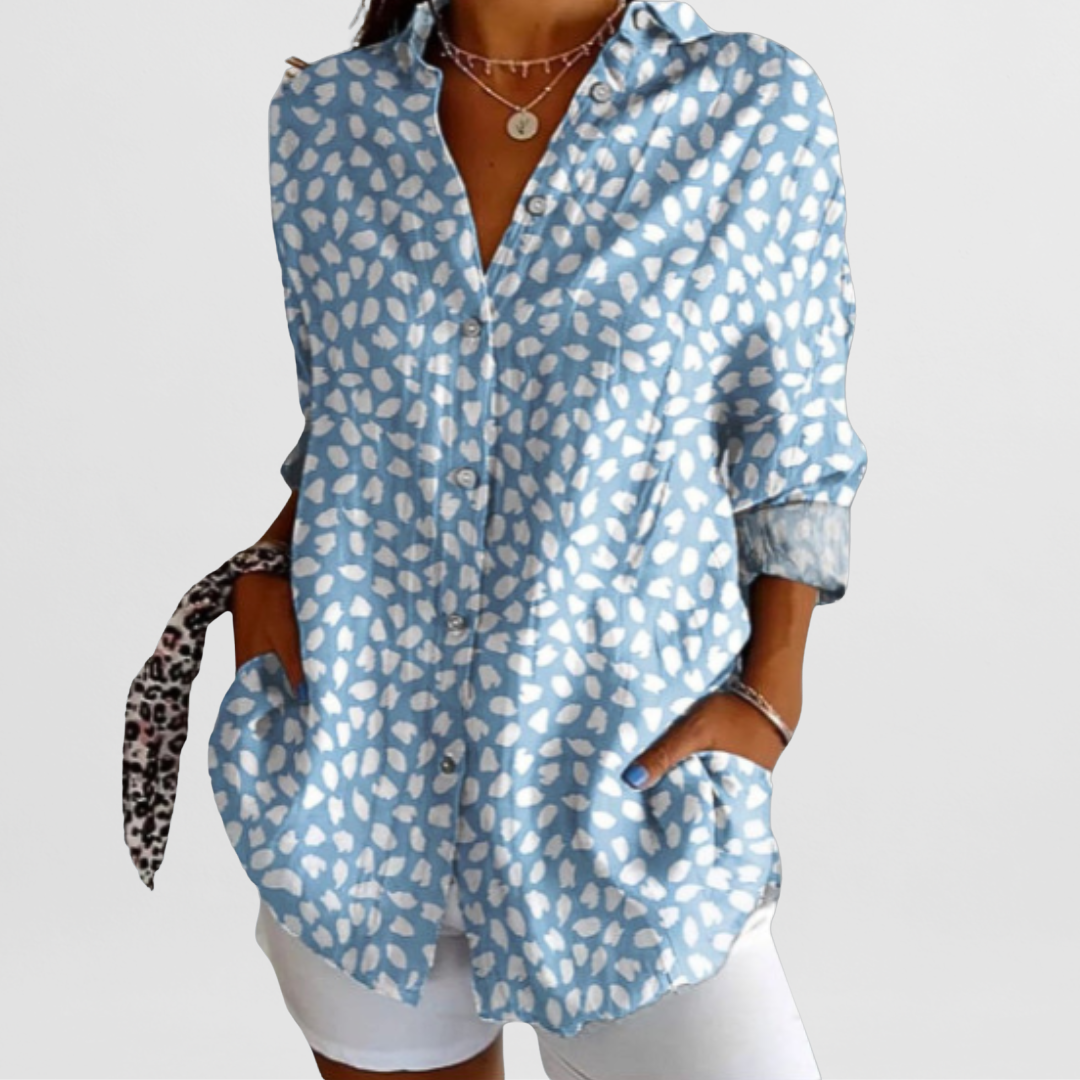 Vibrant ladies' tropical floral blouse, loose fit, perfect for casual summer wear. Features button front.