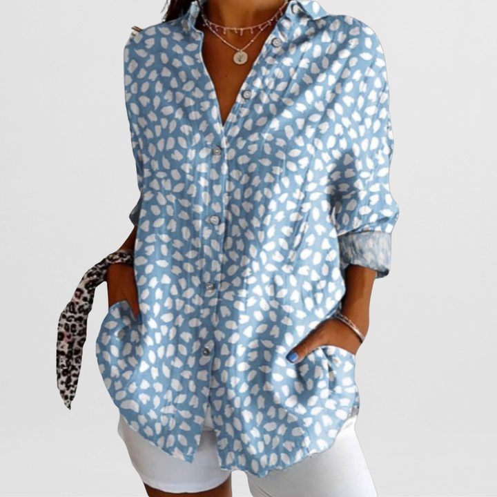 Vibrant ladies' tropical floral blouse, loose fit, perfect for casual summer wear. Features button front.