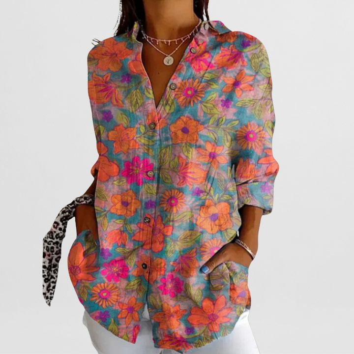 Loose fit ladies' tropical floral blouse with vibrant colors, button front, and long sleeves for elegant summer fashion.