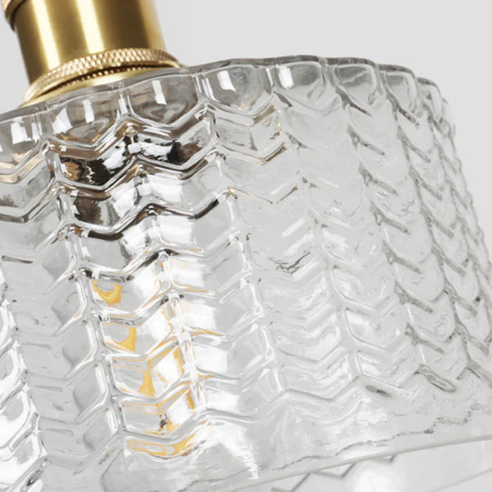 Vintage cylindrical glass pendant lamp casting warm glow; elegant centerpiece for home decor. Perfect for living and dining a