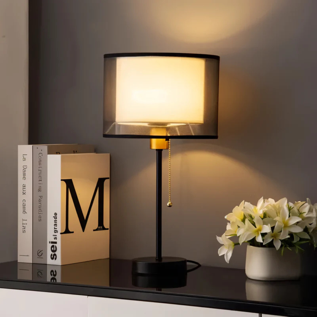 Classic vintage table lamp with dual fabric shades, creating warm LED ambient light for living room decor.