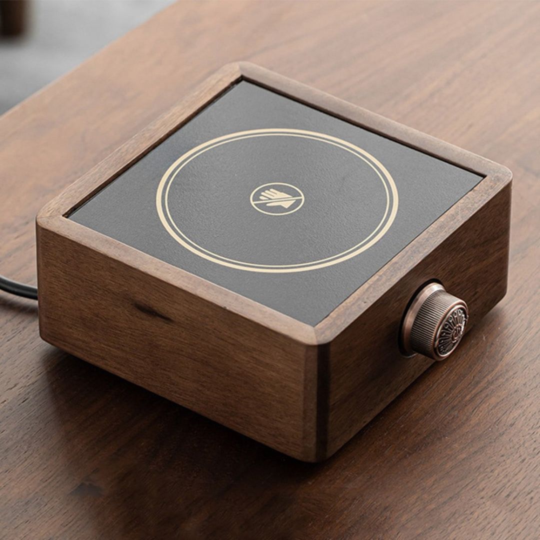 Close-up of walnut electric tea warmer's adjustable temp dial, precise control for hot drinks.