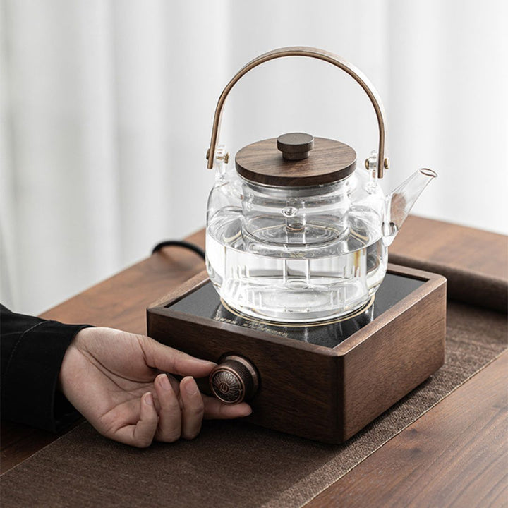 Compact walnut electric tea warmer with infrared heating, keeps drinks warm with adjustable temperature.