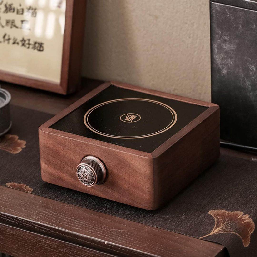 Rich walnut grain on an electric tea warmer, combining elegant home decor with adjustable heating.