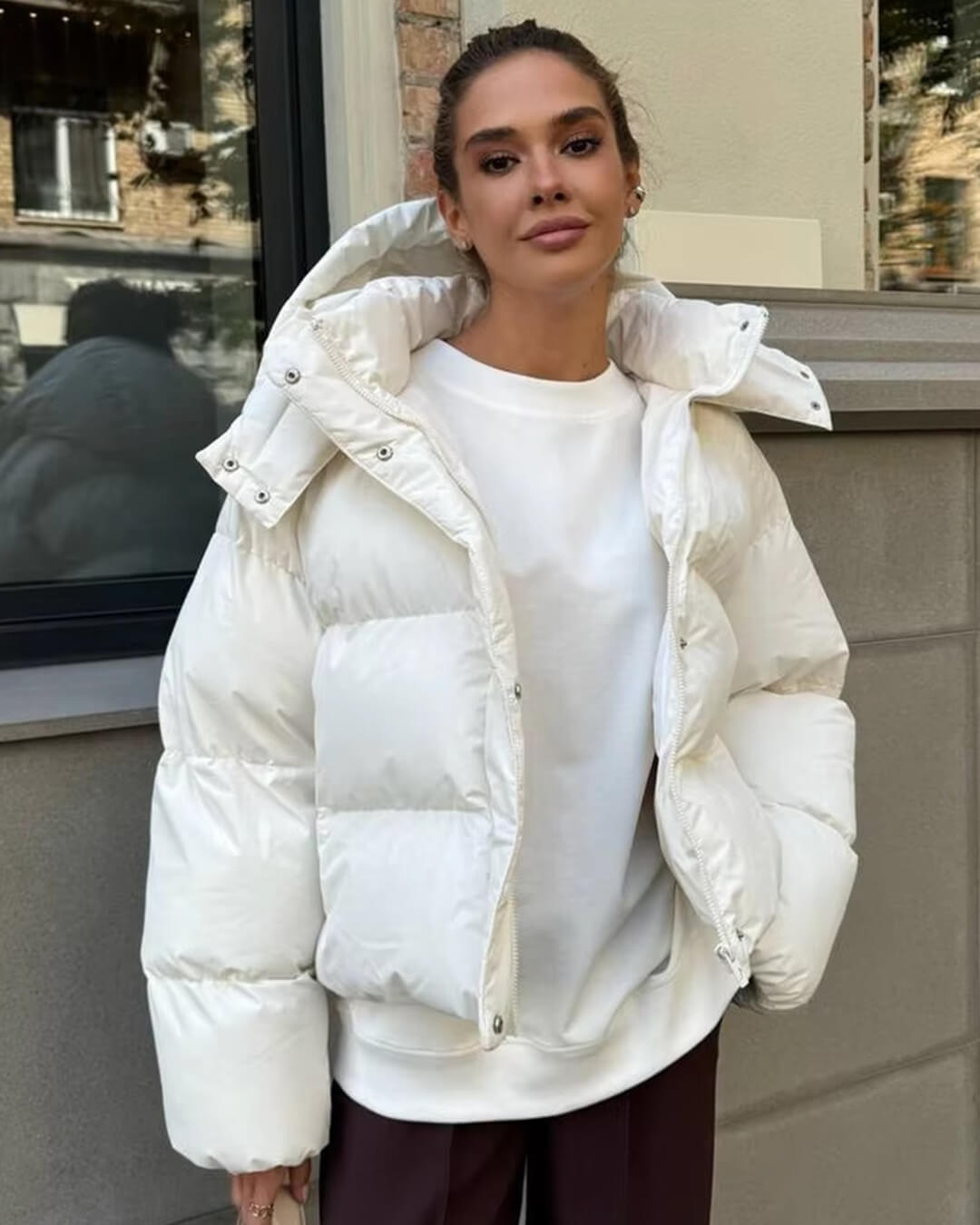 Everyday women's hooded puffer coat in a neutral color, providing warmth and comfort in winter.