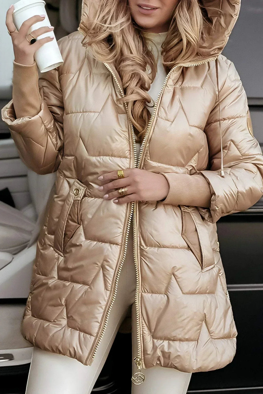 Close-up of the hooded detail on a women's long padded winter jacket, showcasing softness
