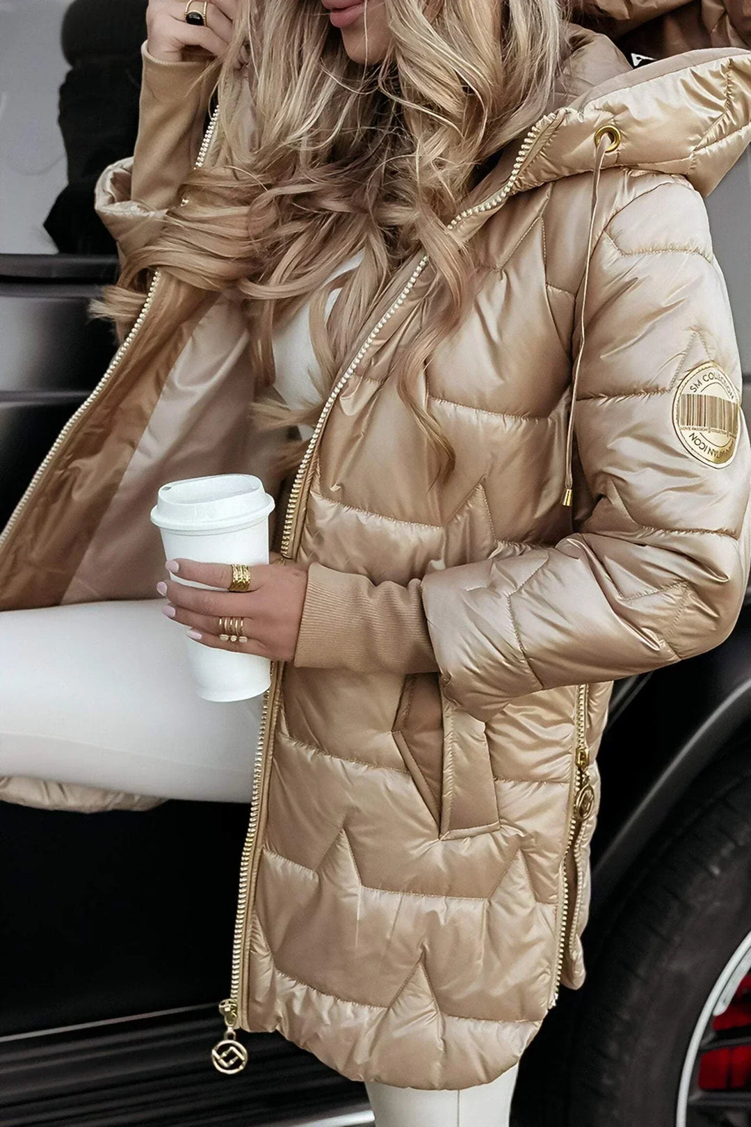 Side view of a women's extra long padded hooded winter jacket, demonstrating full coverage
