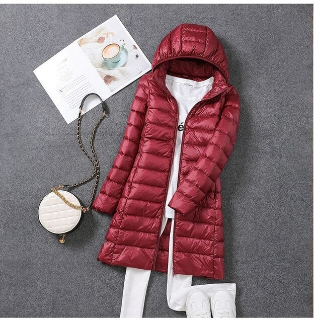 Warm women's long puffer jacket with detachable hood and down fill, perfect for winter outerwear