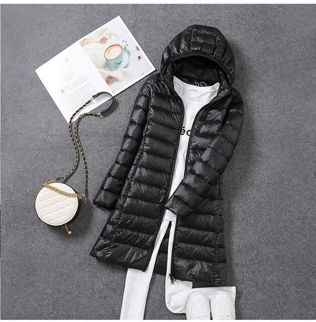 Stylish women's winter coat, a long puffer jacket with classic quilting and detachable hood
