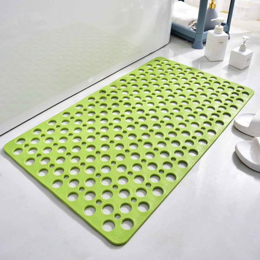 Close-up of a non-skid shower mat showing textured surface and multiple drain holes for hygiene