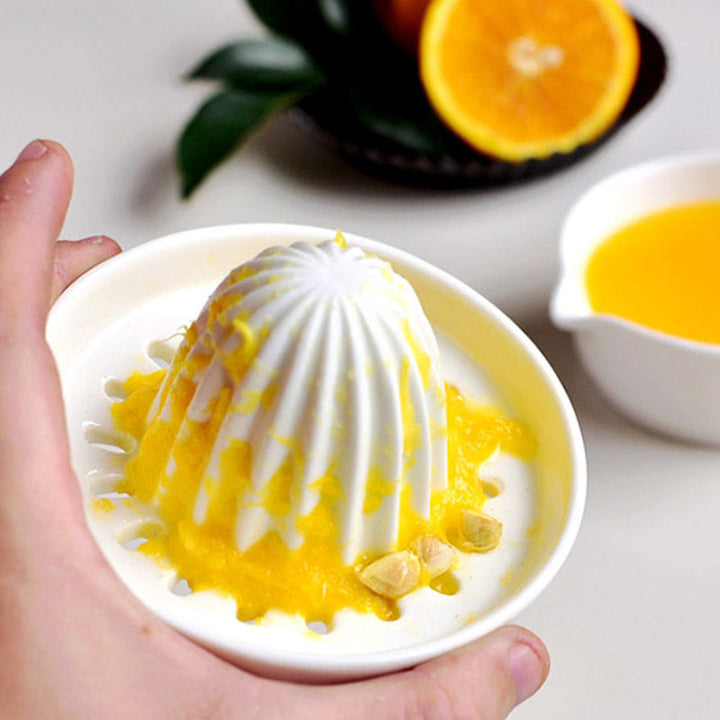 Sturdy ceramic manual juicer, great for extracting fresh juice from lemons, limes, and small oranges.