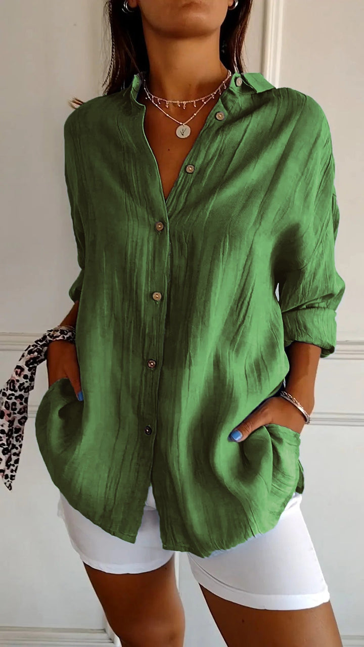 Woman wearing a white long sleeve casual button-down shirt, styled for everyday comfort.