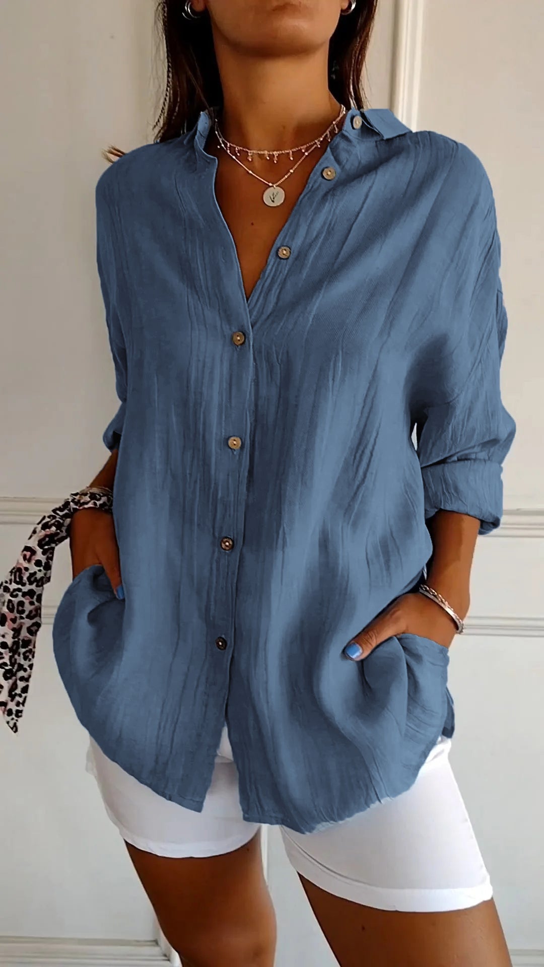 Detail of the button placket on a women's chic long sleeve casual cotton blend shirt.