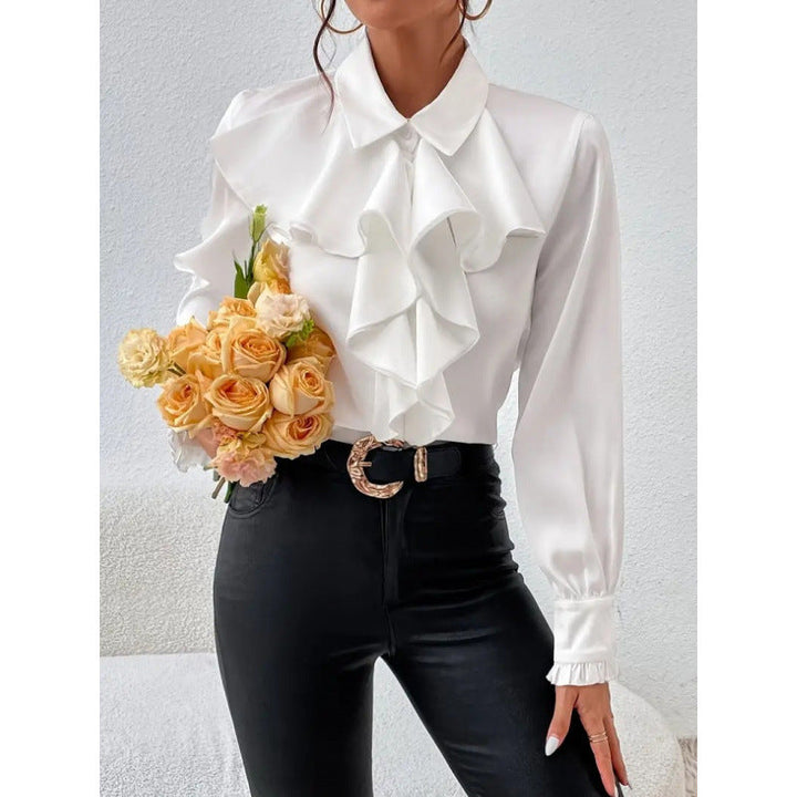 Elegant white long-sleeve blouse with ruffles, perfect for office wear or sophisticated casual outfits.