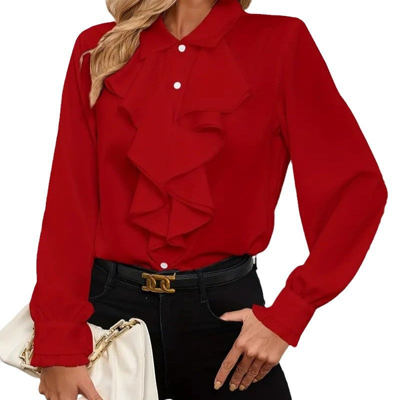 Fashionable women's apparel: a white ruffle top with sophisticated long sleeves, embodying modern style.